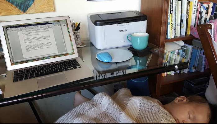 A photo of an open laptop and a sleeping baby - a mama carving out time to write